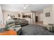 Comfortable living room flowing into the dining area and kitchen, perfect for entertaining at 17061 W Peregrine Ln, Surprise, AZ 85387