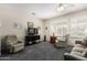 Comfortable living room featuring cozy seating, neutral decor, and large windows with shutter blinds at 17061 W Peregrine Ln, Surprise, AZ 85387