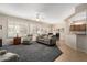 Spacious living room with plush carpeting, plantation shutters, and comfortable seating area at 17061 W Peregrine Ln, Surprise, AZ 85387