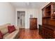 Comfortable living room featuring wood floors, a sofa and a wooden hutch at 17061 W Peregrine Ln, Surprise, AZ 85387