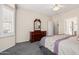 Well-lit primary bedroom with plush carpeting, shutters, and ensuite access at 17061 W Peregrine Ln, Surprise, AZ 85387