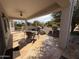 Covered patio with stone tile flooring, outdoor seating, and a view of the backyard at 17061 W Peregrine Ln, Surprise, AZ 85387