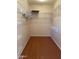 Large walk-in closet with ample shelving and rod at 17061 W Peregrine Ln, Surprise, AZ 85387