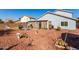 Spacious backyard featuring gravel landscaping, an outdoor seating area, and a large grassy field at 1937 W Burgess Ln, Phoenix, AZ 85041