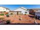 Backyard with gravel landscaping, a lawn tractor, and outdoor seating at 1937 W Burgess Ln, Phoenix, AZ 85041