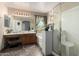 Bathroom featuring double sink vanity, stained glass window, soaking tub, and glass-enclosed shower at 1937 W Burgess Ln, Phoenix, AZ 85041