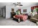 Bright bedroom with patterned bedspread, and an eclectic array of furniture and decor at 1937 W Burgess Ln, Phoenix, AZ 85041