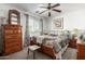 Cozy bedroom with a ceiling fan, window, and comfortable-looking quilted comforter at 1937 W Burgess Ln, Phoenix, AZ 85041