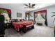 Spacious bedroom featuring decorative curtains, ceiling fan and leopard print accents at 1937 W Burgess Ln, Phoenix, AZ 85041