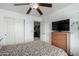 Bedroom featuring a bed with a patterned bedspread, plus television and closet at 1937 W Burgess Ln, Phoenix, AZ 85041