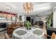 Open-concept dining room flows into living area, showcasing a modern chandelier above dining table at 1937 W Burgess Ln, Phoenix, AZ 85041