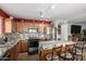 Well-lit kitchen with stainless steel appliances, granite countertops, tile backsplash, and wooden cabinets at 1937 W Burgess Ln, Phoenix, AZ 85041