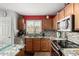 Bright kitchen with granite countertops, stainless steel appliances, and tiled backsplash at 1937 W Burgess Ln, Phoenix, AZ 85041