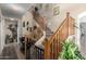 Staircase with wooden banister and carpeted steps, complemented by decorative wall art and lush plants at 1937 W Burgess Ln, Phoenix, AZ 85041