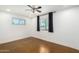 Simple bedroom with brown stained concrete floors and ceiling fan at 2317 W W Whitton Ave Ave, Phoenix, AZ 85015