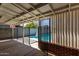 View of the pool through a covered patio with brick wall at 2317 W W Whitton Ave Ave, Phoenix, AZ 85015