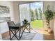 Modern office featuring a large window view of the backyard and a sleek, contemporary desk at 24084 N 77Th St, Scottsdale, AZ 85255