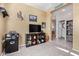 Comfortable living room with television on shelving unit and an open doorway to another room at 24338 W Albeniz Pl, Buckeye, AZ 85326