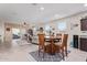 Open-concept living room with a view of the dining area, featuring bright lighting and tile flooring at 24338 W Albeniz Pl, Buckeye, AZ 85326