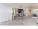 Spacious living room with tile floors, large TV stand and sliding glass door to the outside at 24338 W Albeniz Pl, Buckeye, AZ 85326