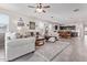 Bright living area showcases tile flooring, neutral furniture, and seamlessly connects to the dining area at 24338 W Albeniz Pl, Buckeye, AZ 85326