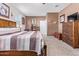 Bedroom shows a bed, windows, carpet, and walls decorated with rustic-style hangings at 24338 W Albeniz Pl, Buckeye, AZ 85326