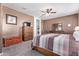 Bedroom showcases carpeting, ceiling fan, wooden furniture, and neutral-toned walls at 24338 W Albeniz Pl, Buckeye, AZ 85326