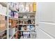 Organized walk-in pantry offers ample storage with multiple shelves filled with various items at 24338 W Albeniz Pl, Buckeye, AZ 85326