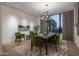 Elegant dining room features a statement chandelier and green armchairs at 24923 N 91 St, Scottsdale, AZ 85255