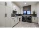 Bright laundry room with ample cabinetry and modern washer/dryer at 24923 N 91 St, Scottsdale, AZ 85255