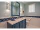 Powder room with blue vanity and hexagonal tile flooring at 25453 N 113Th Way, Scottsdale, AZ 85255