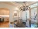 Formal dining room with a dark wood table and access to a courtyard at 25453 N 113Th Way, Scottsdale, AZ 85255