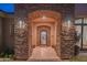 Elegant entry with stone arch and iron door at 25453 N 113Th Way, Scottsdale, AZ 85255