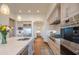 Modern kitchen with stainless steel appliances, custom cabinetry, and an eat-in island at 25453 N 113Th Way, Scottsdale, AZ 85255