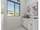 Wet bar with white cabinets, granite countertop and picture window at 2706 E Lovebird Ln, Gilbert, AZ 85297