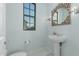 Elegant powder room with pedestal sink and ornate mirror at 2706 E Lovebird Ln, Gilbert, AZ 85297