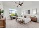 Main bedroom with plush carpet, large window and ceiling fan at 2706 E Lovebird Ln, Gilbert, AZ 85297