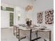 Modern dining room with a large table and statement light fixture at 2706 E Lovebird Ln, Gilbert, AZ 85297