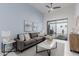 Living room with gray sectional sofa and access to patio at 2706 E Lovebird Ln, Gilbert, AZ 85297