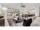 Living room with open kitchen, sliding doors to the pool area at 2706 E Lovebird Ln, Gilbert, AZ 85297