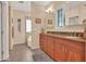 Elegant bathroom featuring double sinks, wood cabinets, and a separate tub, creating a spa-like retreat at 311 W Georgia Ave, Phoenix, AZ 85013