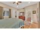 Bright bedroom featuring a large window, hardwood flooring, and ample closet space with natural light at 311 W Georgia Ave, Phoenix, AZ 85013