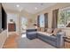 Cozy living room with a sectional sofa, leading to an outdoor deck with sliding glass doors at 311 W Georgia Ave, Phoenix, AZ 85013