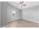 Bedroom with a ceiling fan and natural light from a window overlooking street at 320 E Mckellips Rd # 50, Mesa, AZ 85201