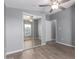 Bedroom featuring ceiling fan and mirrored closet doors overlooking street at 320 E Mckellips Rd # 50, Mesa, AZ 85201