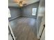 Bright bedroom with gray walls, wood-look flooring, and a window at 320 E Mckellips Rd # 50, Mesa, AZ 85201