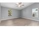 Spacious primary bedroom with wood-look flooring and natural light from two windows at 320 E Mckellips Rd # 50, Mesa, AZ 85201