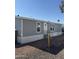 Gray single-wide manufactured home with a small yard at 320 E Mckellips Rd # 50, Mesa, AZ 85201