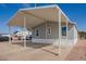 Exterior of single-story home features a carport with gravel landscaping on a sunny day at 320 E Mckellips Rd # 50, Mesa, AZ 85201