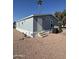 Gray manufactured home with steps and desert landscaping at 320 E Mckellips Rd # 50, Mesa, AZ 85201